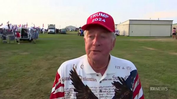 Rally attendees react to the shooting.