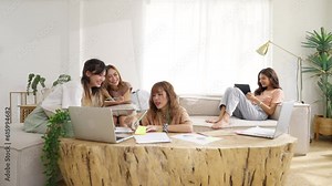 4K Group of Young Asian man and woman university college students using laptop computer for research and brainstorming discussion analyze ideas making project report together in living room at home.