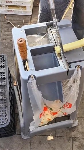 cutting a fresh sugar cane precisely into several pieces using a manual metal tool