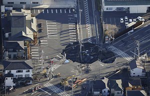 Japan tries to rescue man stuck in sinkhole
