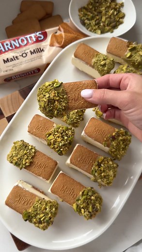 ARNOTT'S MALT 'O' MILK ICE CREAM SANDWICHES 🍦 dipped in pistachio. Full recipe below! Ingredients: - 2 packets Arnott's Malt 'O' Milk biscuits - 600ml thickened cream - 1 can condensed milk - 6 tbsp pistachio spread - 6 tbsp crushed pistachios Method: 1. Combine the cream and condensed milk in a bowl and whip until a soft peak forms 2. Line a baking dish with baking paper and evenly place the Malt 'O' Milk biscuits facing down side by side 3. Evenly spread the cream mixture on top 4. Top with t