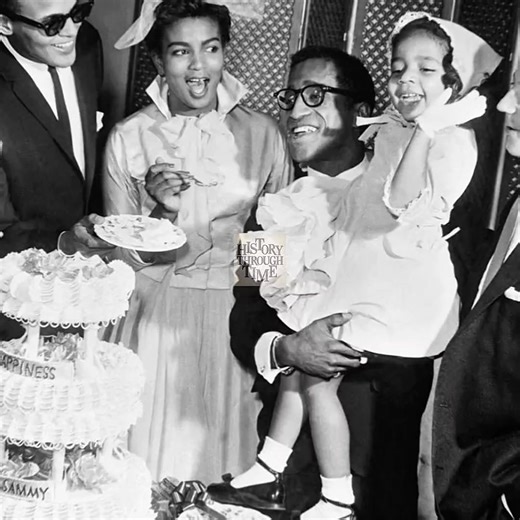 "Sammy Davis Jr. and his first wife, Loray White, are photographed on their wedding day in Las Vegas, circa January 1958. The ceremony took place at the iconic Sands Hotel, a centerpiece of the city’s vibrant mid-century entertainment scene. Davis, one of the most dynamic performers of the era, was at the height of his career, known for his work on stage, screen, and with the famed Rat Pack. Loray White, a talented singer and actress in her own right, brought elegance and charm to the occasion. 