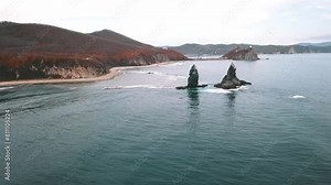 Two planes soaring over a beautiful landscape of water, mountains, and sky