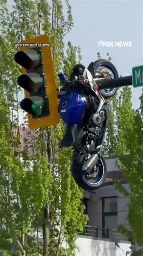 Motorcycle seen HANGING from traffic light after violent crash #shorts #us #news #viral