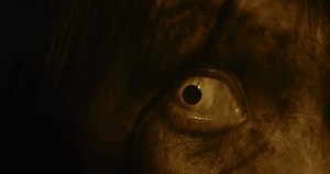 Horror scene of a mysterious Scary closeup eyes Asian ghost woman creepy have hair covering the face looking to camera at abandoned house with background dark scene movie at night, festival Halloween