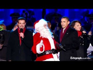 President Barack Obama sings with Father Christmas