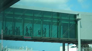 People Come Out of Plane by Jetway Jet Bridge. Flight Arrived at the Airport