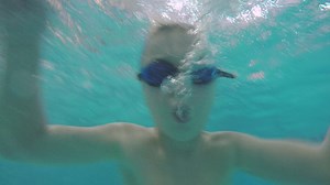 Child diving in the pool, underwater view