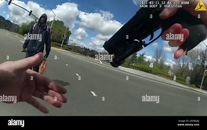 This image from body-worn camera video provided by the Contra Costa County Sheriff’s Office shows Tyrell Wilson, left, holding a knife in his right hand, in front of Officer Andrew Hall in the middle of an intersection, March 11, 2021, in Danville, Calif. Graphic body camera footage released April 21, 2021, shows Hall call out to Wilson, accusing him of jaywalking and throwing rocks, and then shoots him in the middle of the intersection within seconds of asking him to drop his knife. This and an