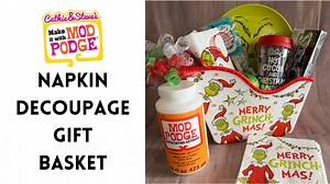 Even a Grinch will love this hot cocoa gift basket! Cathie from Handmade Happy Hour with Cathie Filian and Steve Piacenza is customizing plain gift baskets with napkins and Mod Podge. Grab some holiday themed paper napkins, plain gift tubs and your favorite Gloss, Matte or Satin Mod Podge. 💛 Learn more about and shop Mod Podge at https://plaidonline.com/brands/mod-podge​ 🎨 Watch more Make It With Mod Podge: http://bit.ly/MakeItWithModPodge | Plaid Crafts