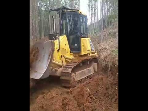 Komatsu D51EX Bulldozer in Action Splitting Forest Land for Road Construction