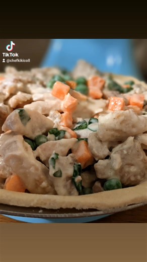 Mum's Chicken Pie 2 8" pie crust -top and bottom Filling: 6 - 8 boneless chicken thighs 1 onion, chopped 1 Tablespoon olive oil Salt to taste 1 1/2 cups fresh or frozen peas and diced carrots 1/2 cup fresh or frozen corn 1 tsp black pepper 1 tsp garlic powder 1 tsp. paprika 2 Tablespoons dried or fresh basil 2 Tablespoons butter 2 Tablespoons all-purpose flour 1/2 teaspoon cornstarch 1 1/2 cups milk or light cream 2 teaspoons chicken bouillon powder 1 egg, beaten Preheat oven to 400 degrees F.. 