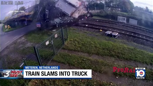 Train crashes through truck on tracks, spilling cargo and debris everywhere