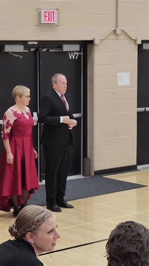 Have you wondered how a ballroom competition works? Competitors dance heats, 1.5-2 minute performances of a specific style for a given level and age of dancer. Smaller competitions may have multiple levels and/or age groups on the floor at the same time. Here you see Ed and Ceaven waiting in what's called the "on deck" area before one of their heats. The wonderful lady holding the clipboard is the on deck captain whose job it is to make sure all the right couples are present. Ed then escorts Cea