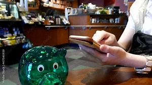 Hand browsing website on iPhone inside Starbucks store with 4k resolution.