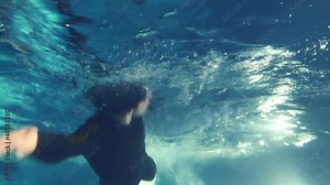 Underwater view of professional swimmer in swimming pool, 4k slow motion 60fps
