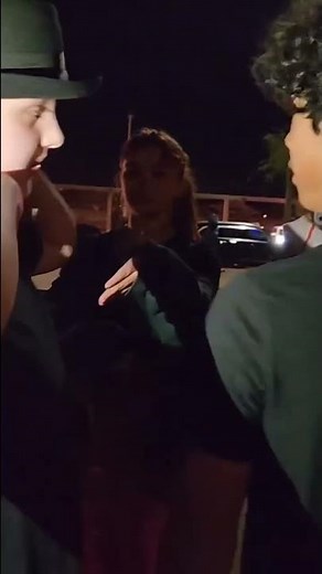 Two kids kissing for money after a movie night at school