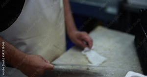 Fish monger preparing fish inside seafood market
