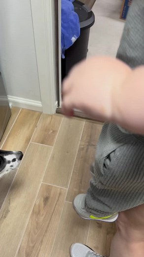 Toddler Explores a Garage with a Red Car