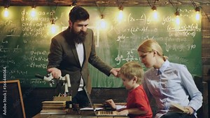 Father, mother and child son doing homework writing and reading at home. Education, family lifestyle, homeschooling concept. School community partnership models.