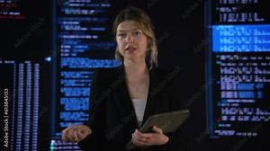 High-tech startup concept: An innovative female software engineer stands, conducting big data analysis on a wall screen, talking about programming code. Developing a futuristic e-commerce app using Stock Video
