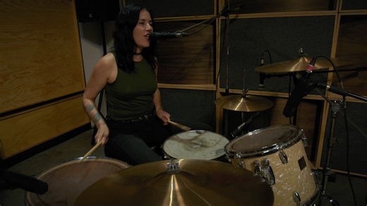 Female drummer playing and singing in a studio - Free Stock Video