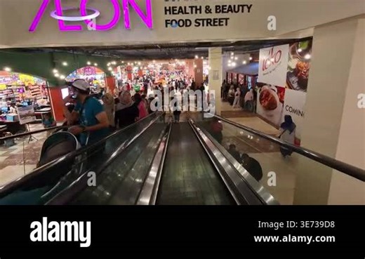 Bandung, Indonesia, April 3, 2026. First-Person Video of entering AEON Retail in Paris Van Java Mall Bandung by descending the escalator. 4K Time-lapse Footage of the crowd at the mall Stock Video Footage - Alamy