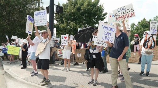 People rally outside of CDC headquarters during vaccine meeting
