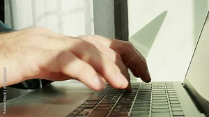 man typing on laptop,closeup video of young businessman busy working on laptop