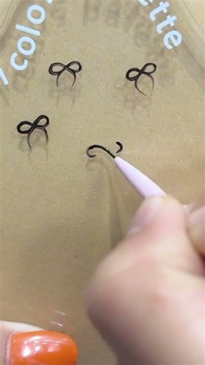 a person is create an interesting ribbon image on a glass