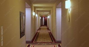 Camera glides through a long hotel corridor angle shot