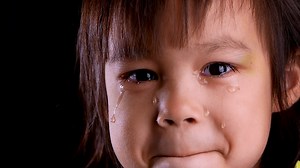 Download Close-up face portrait of sad little child crying with tears for free