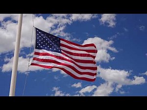 Stock Video - American flag waving in slow motion at half mast