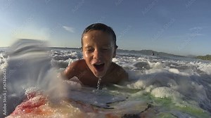 Boy / kid surfing - jumping waves Body Board / boarding at the beach, surfing, surf