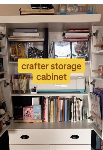 welcome to my craft cabinet where i store all of my paints, sticker printers, sketchbooks, glue, markers, and even a laser printer! #craftcabinet #craftstorage #artsupplyorganization #storagecabinet #tiktokshopspringglowup