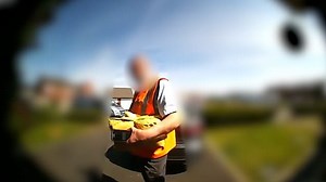 Doorbell footage captures postman appearing to boot family's dog