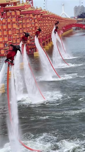 A breathtaking water jet pack (flyboard) performance with five performers soaring together above the river in perfect harmony. Set against the backdrop of Hetou Old Street during the Tang Dynasty Baixi Festival, this display combines martial arts flair with stunning visual impact. 🎥筱白 | Enjoy Music and Arts