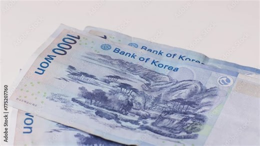 girl's hands counting Korean banknotes