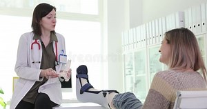 Female Doctor Shows Feet Bones Model To Woman with Cast Stock Video - Video of hospital, medical: 335909333