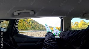 man stick out legs of car window