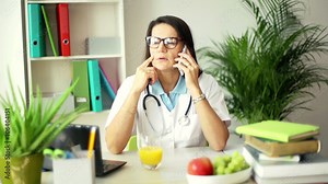 Doctor talking on cellphone and receiving bad news while talking on cellphone