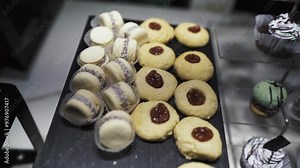 Tray of raspberry jam cookies and assorted cakes, cornstarch alfajor. Hotel breakfast.