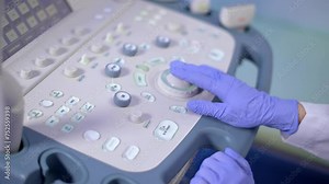 Doctor operates medical equipment. Close-up hand pressing buttons
