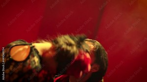 Beautiful couple dancing latin dance . Professional dancers dancing flamenco, rumba or salsa on red background. Couple in spanish dress performs dance movement. Shot ARRI ALEXA Cinema Camera .