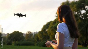 Young woman learn how to use quadcopter drone, hold remote controller Stock Video