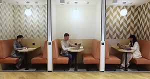 clip-1099822923-employees-working-separate-booths-freelance-cafe-co-working
