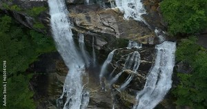 Whitewater Falls in Nantahala National Forest, North Carolina, USA. Beautiful landscape of high waterfall with falling down clear water from rocky boulders between green lush woods