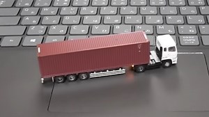 Tiny RC Truck And Trailer Motors Around Tabletop