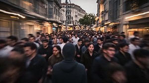 A Bustling Street Scene Captured in Motion: People Walking Through a Vibrant Urban Environment Amidst Evening Ambience and Atmospheric Lighting | Premium Stock Video Footage