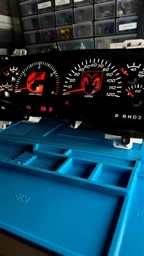 Custom build for a 1998–2002 Dodge Ram for @lanced.99 featuring our Ram Logo gauge face paired with crisp white LED backlighting. Red emergency lights, a bold red screen tint, red gear selector, and matching red needles give this cluster a striking, uniform look that stands out day or night. Perfect for Ram owners wanting a clean, aggressive aesthetic with a touch of brand pride. #DodgeRam #RamTruck #RamLife #RamNation #RamOwners #MoparOrNoCar #MoparNation #RamObsessed #DodgeTruck #RamLove #RamL